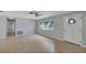 Spacious living room with laminate flooring and large windows providing an abundance of natural light at 2127 Scotland Dr, Clearwater, FL 33763