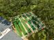 The community shuffleboard area is surrounded by mature trees, offering shade and tranquility at 2127 Scotland Dr, Clearwater, FL 33763