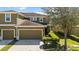 Inviting two-story townhome with lush landscaping and attached garage at 2221 Broadway View Ave, Brandon, FL 33510