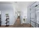 Bright hallway features neutral carpet, and decorative shelving, leading to the staircase and bedrooms at 2221 Broadway View Ave, Brandon, FL 33510