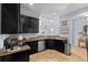 Stylish kitchen featuring dark cabinetry, granite countertops, and modern lighting at 2221 Broadway View Ave, Brandon, FL 33510