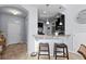 Convenient bar seating, stainless steel refrigerator, and well-lit entryway enhance this inviting kitchen at 2221 Broadway View Ave, Brandon, FL 33510