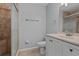 Bathroom with a shower and a light-colored single sink vanity with neutral countertop and tile flooring at 2411 Lancaster Dr, Sun City Center, FL 33573