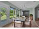 Bright dining room with floor to ceiling windows, seating for six, and a ceiling fan at 2411 Lancaster Dr, Sun City Center, FL 33573