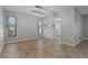 Spacious dining area with blue curtains, open to kitchen area and natural lighting at 2411 Lancaster Dr, Sun City Center, FL 33573
