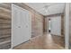 Inviting entryway featuring tiled floors, accent wall, closet, and a glass-paneled front door at 2411 Lancaster Dr, Sun City Center, FL 33573