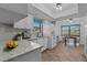 Charming kitchen features granite counters, updated appliances, and breakfast nook at 2411 Lancaster Dr, Sun City Center, FL 33573