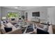 Cozy living room with stylish furniture, a large TV, and lots of natural light at 2411 Lancaster Dr, Sun City Center, FL 33573