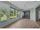 Light filled room with tile flooring, big sliding glass door, and large windows overlooking the backyard at 2411 Lancaster Dr, Sun City Center, FL 33573