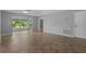 Spacious living room with tile floors, ceiling fan, and large windows with backyard views at 2411 Lancaster Dr, Sun City Center, FL 33573