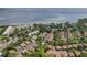 Aerial view of a community, showing homes with trees and green spaces near the water at 2934 Lichen Ln # A, Clearwater, FL 33760