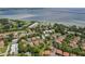 Stunning aerial view of waterfront community featuring lush landscaping, a golf course, and scenic views of the bay at 2934 Lichen Ln # A, Clearwater, FL 33760