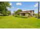 Exterior view of home with green lawn and lush landscaping at 2934 Lichen Ln # A, Clearwater, FL 33760