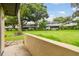 A grassy backyard with views of neighboring houses and mature shade trees at 2934 Lichen Ln # A, Clearwater, FL 33760