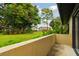 A view of the landscaped backyard from the edge of the patio area at 2934 Lichen Ln # A, Clearwater, FL 33760