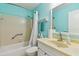 Well-lit bathroom with a shower and tub combination and vanity with gold-toned sink at 2934 Lichen Ln # A, Clearwater, FL 33760