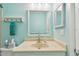 Fresh and clean bathroom featuring a vanity, mirror and colorful blue accent wall at 2934 Lichen Ln # A, Clearwater, FL 33760