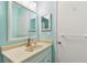 Clean and bright bathroom features a vanity with sink and a large mirror at 2934 Lichen Ln # A, Clearwater, FL 33760