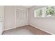 Cozy bedroom with carpet, neutral walls, closet, and window at 2934 Lichen Ln # A, Clearwater, FL 33760