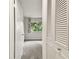 View of a bright bedroom with closet doors and a window offering natural light at 2934 Lichen Ln # A, Clearwater, FL 33760