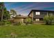 Exterior view of home with front lawn and mature landscaping at 2934 Lichen Ln # A, Clearwater, FL 33760