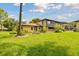 Home exterior with large green lawn and mature landscaping at 2934 Lichen Ln # A, Clearwater, FL 33760