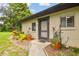 Inviting front entrance with lovely landscaping and potted plants enhancing the curb appeal of this cozy home at 2934 Lichen Ln # A, Clearwater, FL 33760