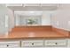 Open kitchen layout with view to the living room with a breakfast bar and white cabinets at 2934 Lichen Ln # A, Clearwater, FL 33760
