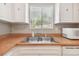 Bright kitchen featuring ample counter space, a stainless steel sink, and plenty of natural light at 2934 Lichen Ln # A, Clearwater, FL 33760