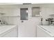 Bright laundry room featuring white shelving and appliances at 2934 Lichen Ln # A, Clearwater, FL 33760