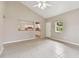 Open living room with high ceilings, tile floors, and natural light, flowing into the adjacent kitchen area at 2934 Lichen Ln # A, Clearwater, FL 33760