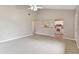 Spacious living room with tile floors, neutral walls, and a pass through to the bright, updated kitchen at 2934 Lichen Ln # A, Clearwater, FL 33760