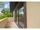 A view of the yard from the patio, through the sliding glass doors of the house at 2934 Lichen Ln # A, Clearwater, FL 33760