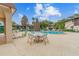 Inviting community pool with outdoor seating, umbrellas, and lush greenery, offering a resort-style living experience at 2934 Lichen Ln # A, Clearwater, FL 33760