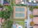 Aerial perspective of well-maintained tennis courts alongside community pool and car parking, ideal for sports enthusiasts at 2934 Lichen Ln # A, Clearwater, FL 33760