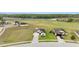 An aerial view of the property and neighborhood including the nearby golf course at 30475 Satinleaf Run, Brooksville, FL 34602