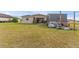 Spacious backyard featuring a patio, shed, and lush green lawn at 30475 Satinleaf Run, Brooksville, FL 34602
