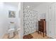 Bathroom featuring tile floor, toilet, shower with curtain, and storage cabinet at 30475 Satinleaf Run, Brooksville, FL 34602