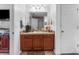 Bathroom featuring a vanity with wooden cabinets, a mirror, and essential toiletries at 30475 Satinleaf Run, Brooksville, FL 34602