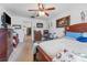 This bedroom offers natural light, a ceiling fan, carpet, and ample furniture at 30475 Satinleaf Run, Brooksville, FL 34602