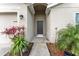 Inviting front entrance of a single-story home, accentuated by lush landscaping and a welcoming walkway at 30475 Satinleaf Run, Brooksville, FL 34602