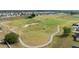 Scenic view of a well-maintained golf course within a residential community, with lush green fairways and neatly arranged homes at 30475 Satinleaf Run, Brooksville, FL 34602