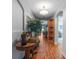 A hallway with wood flooring leads to the living room with a view of the backyard at 30475 Satinleaf Run, Brooksville, FL 34602