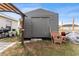 View of the storage shed with a wicker chair in the backyard at 30475 Satinleaf Run, Brooksville, FL 34602