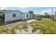 The backyard features a covered patio and a spacious lawn, ideal for relaxation and gatherings at 3207 Coldwell Dr, Holiday, FL 34691