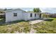 This backyard features a covered patio and a spacious lawn area, perfect for outdoor entertaining and relaxation at 3207 Coldwell Dr, Holiday, FL 34691