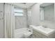Updated bathroom with tub/shower, new vanity, white marble-look tile, and brushed nickel fixtures at 3207 Coldwell Dr, Holiday, FL 34691