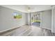 Bedroom with sliding glass doors to the backyard, wood-look floors, and neutral walls at 3207 Coldwell Dr, Holiday, FL 34691