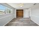 Bedroom with a window, hardwood floors, wooden closet, and natural light at 3207 Coldwell Dr, Holiday, FL 34691