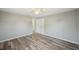 Bedroom with white walls, closet, and wood-look floors at 3207 Coldwell Dr, Holiday, FL 34691